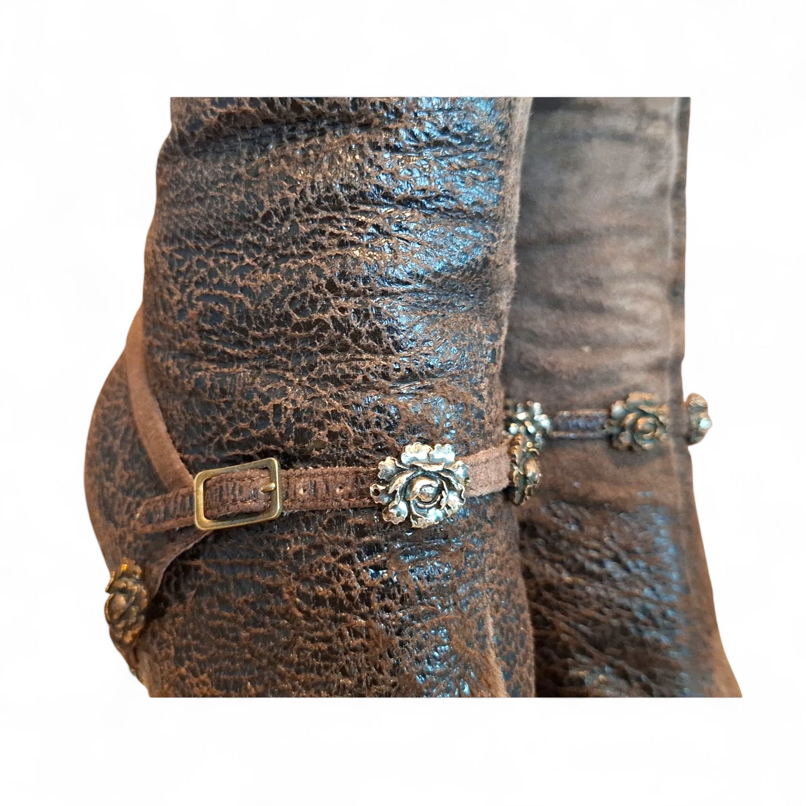 Close-up of a vintage Roberto Cavalli textured brown leather stiletto ankle boot with a metallic buckled ankle strap.