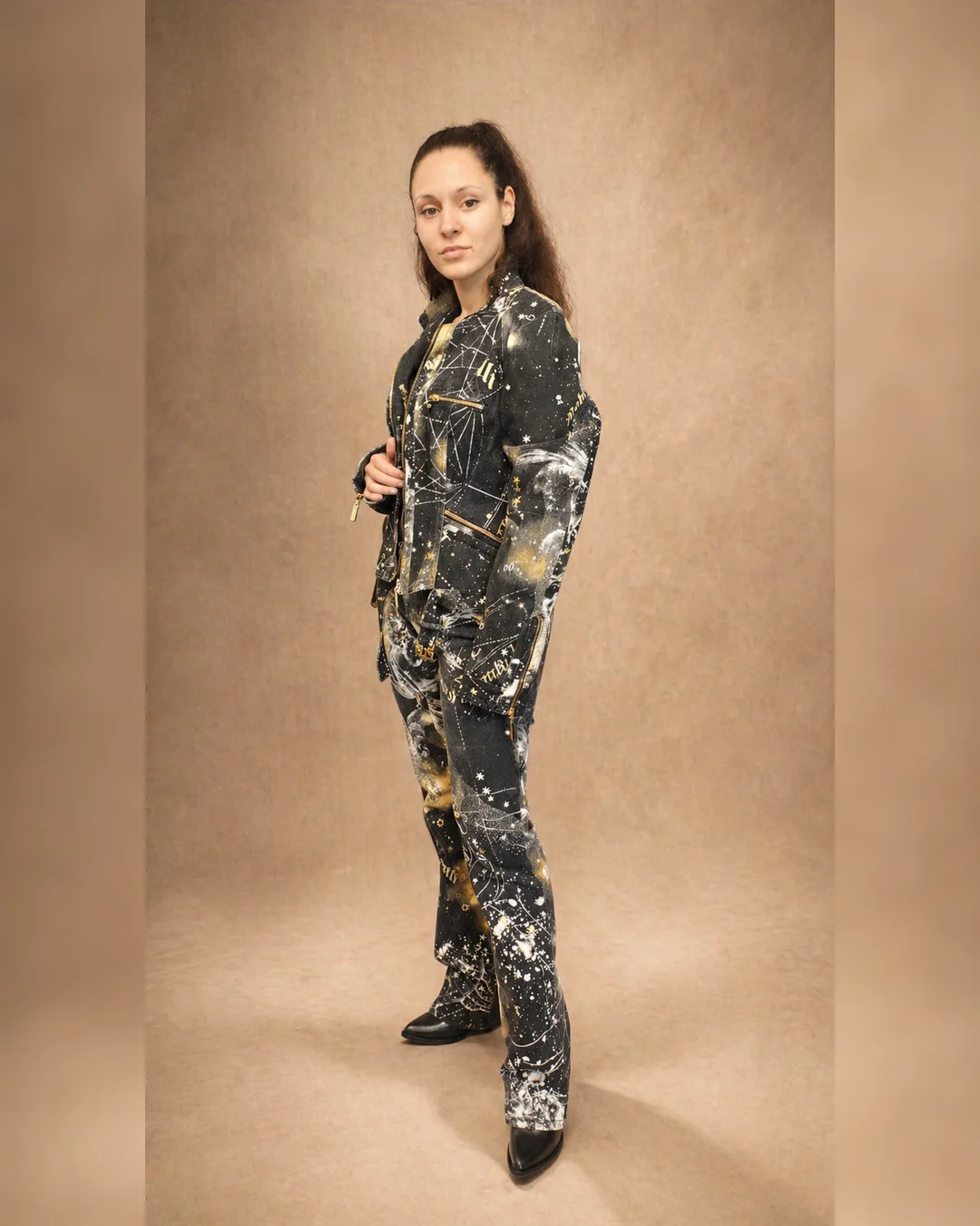 Lia wearing a rare Roberto Cavalli Fall/Winter 2003 zodiac constellation jacket and pants set in dark printed denim with gold details.